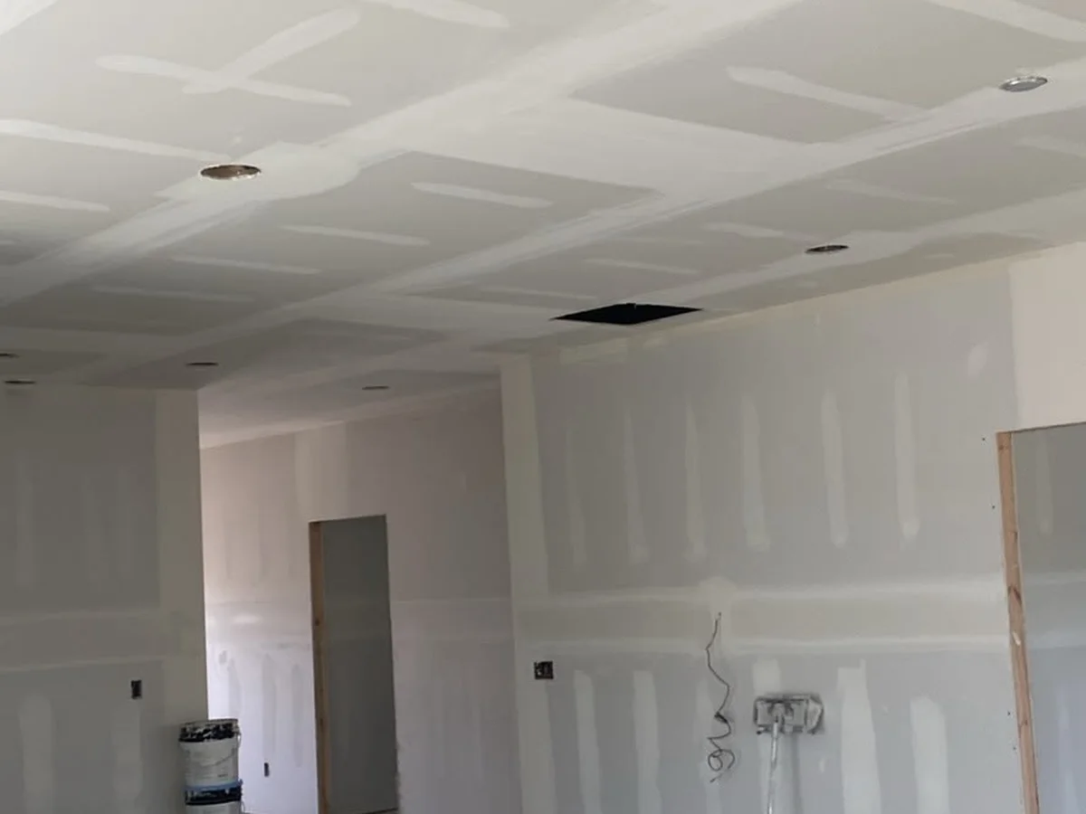 Hallway with drywall hung and screwed off