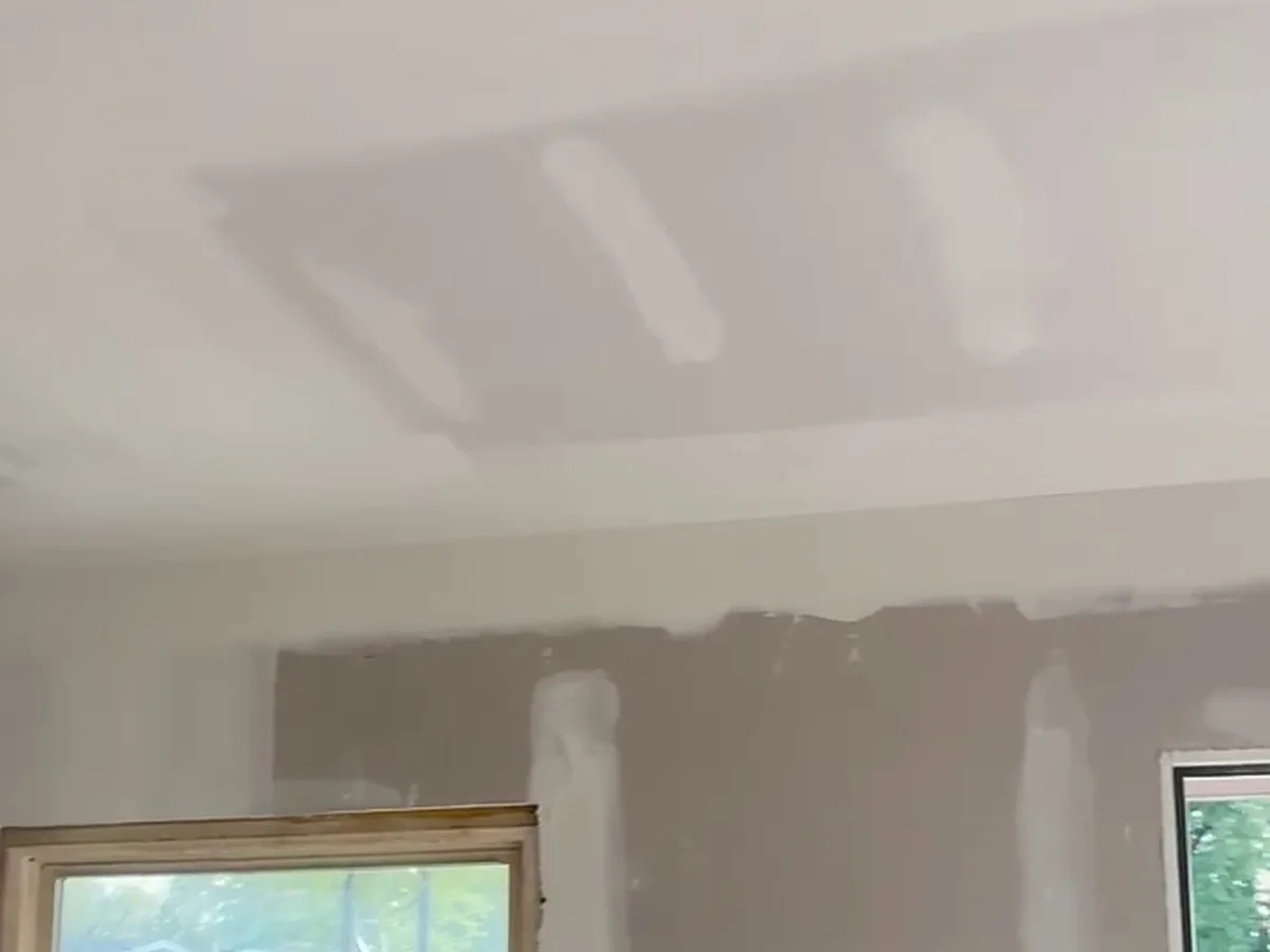 Taped wall beside a window, smooth and ready